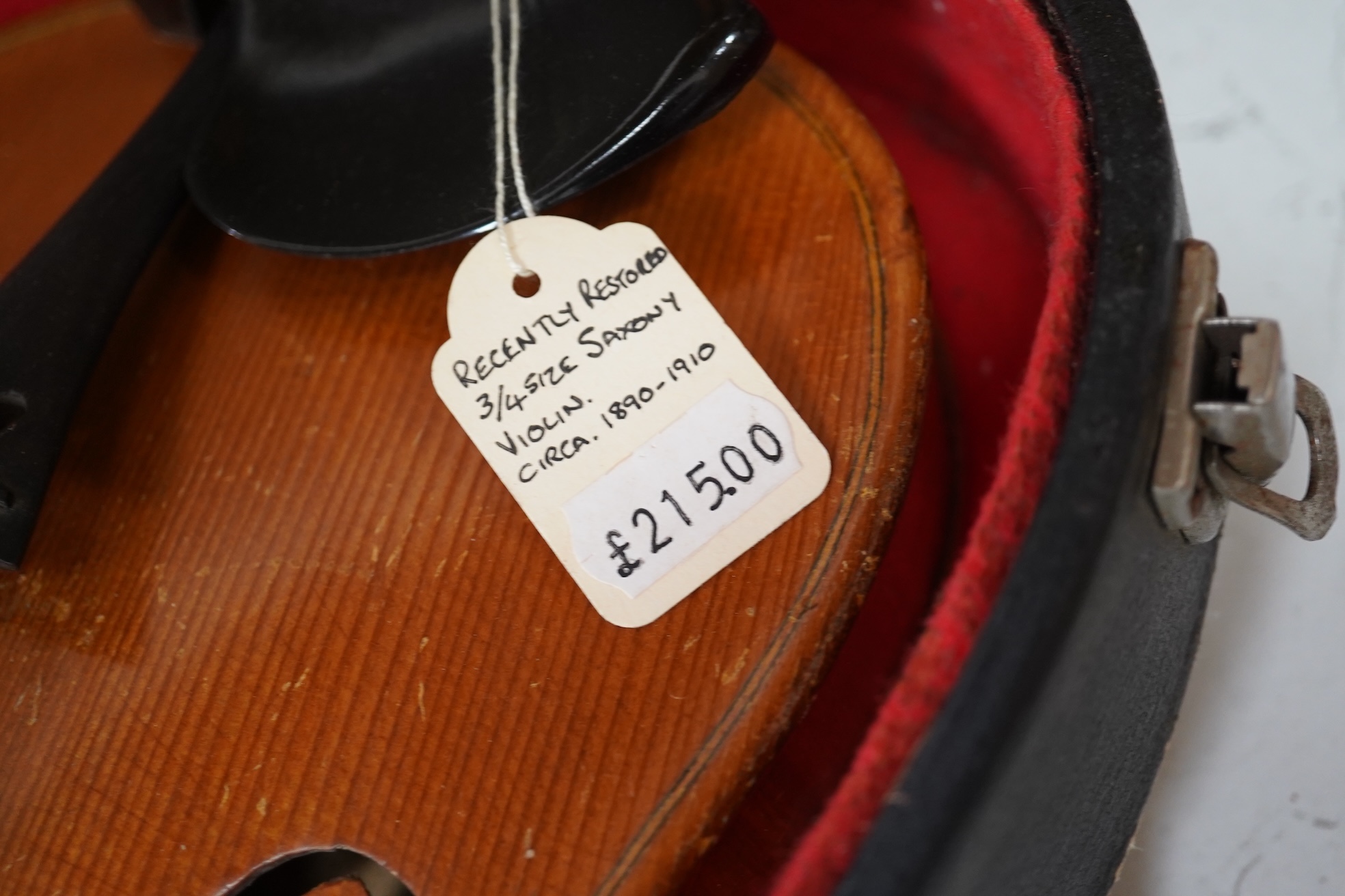 Two cased three quarter size violins, one labelled the London violin Co Ltd, length of back 33.5cm. Condition - both scratched